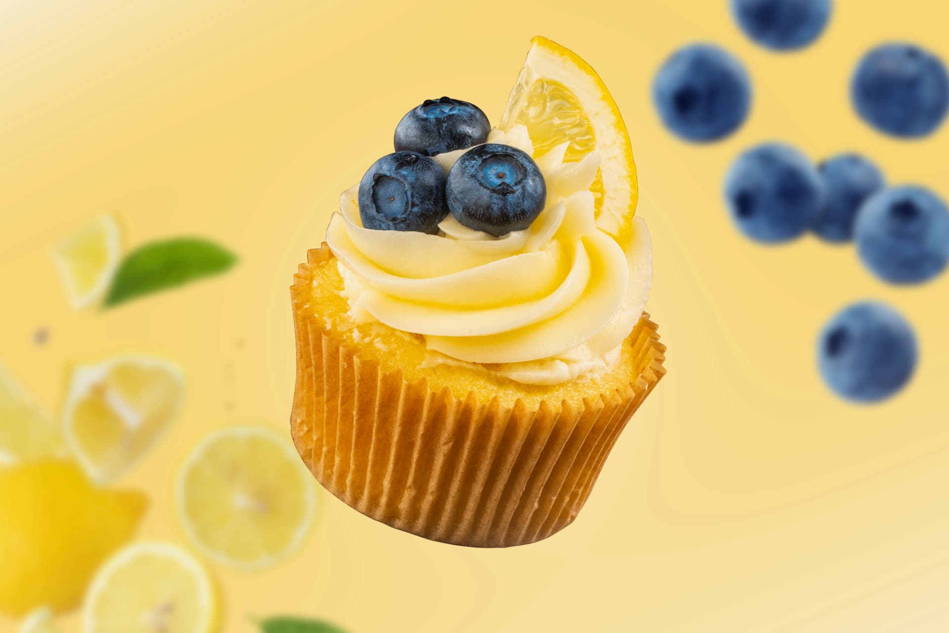 Lemon cupcake with blueberries and a lemon wedge floating against a sunny yellow backdrop